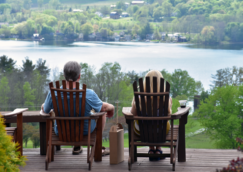 Couple sitting on Keuka Spring deck with wine club package