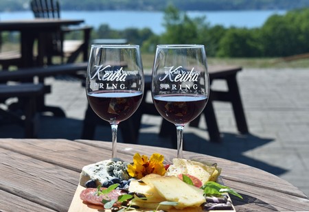 Keuka Spring red wine with cheese board on patio